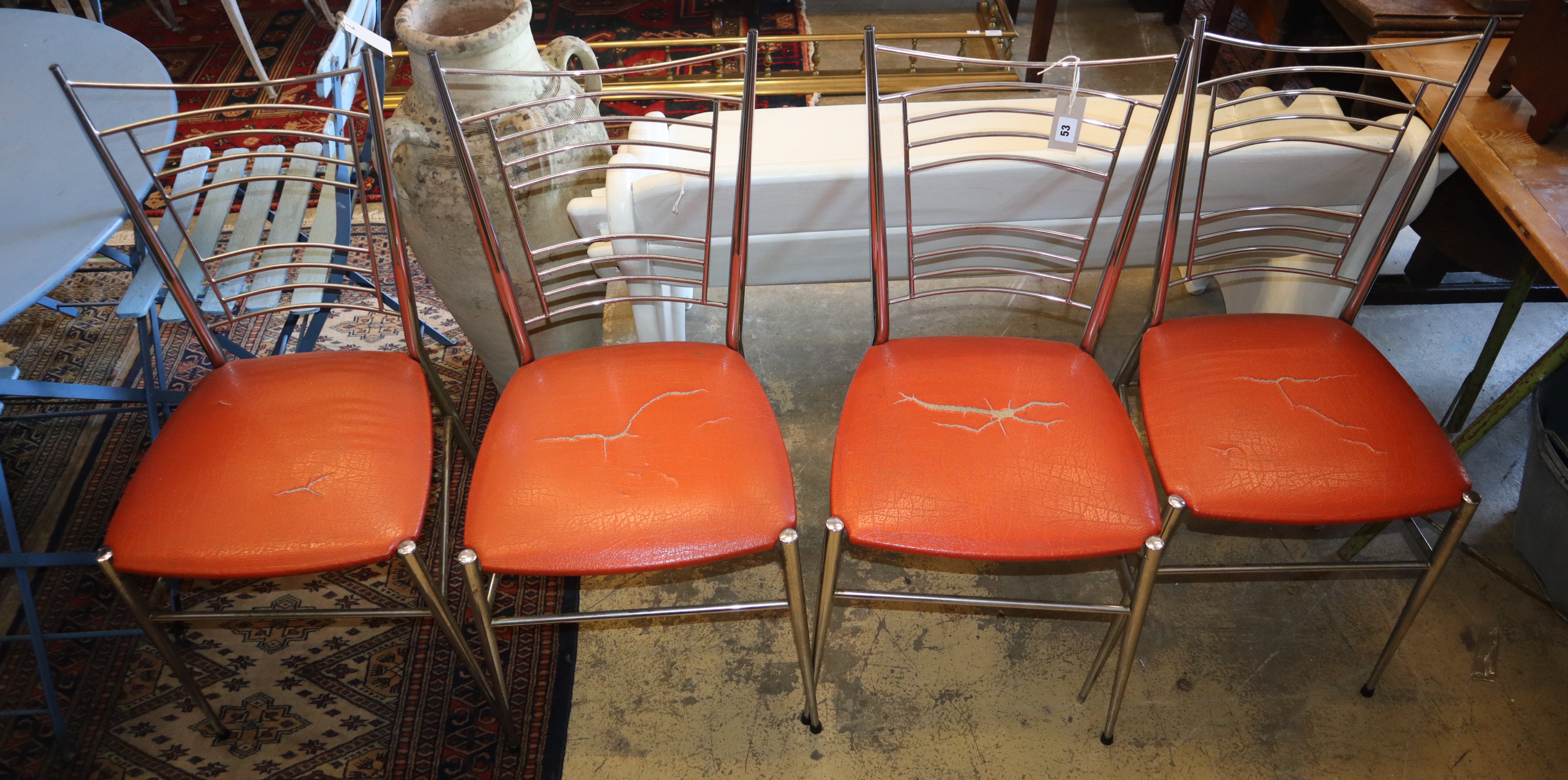 A set of four chrome and leatherette dining chairs